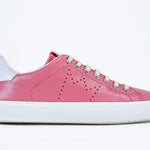 Side profile view of low top pink sneaker with white detailing and perforated crown logo on upper. Full leather upper and white rubber sole.