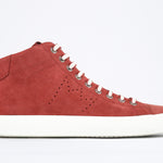  Side profile of mid top sneaker in red suede and leather upper, internal zip and white sole.