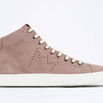  Side profile of mid top sneaker in pink suede and leather upper, internal zip and white sole.