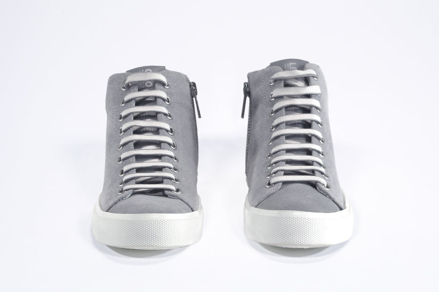 Front view of mid top sneaker with full grey canvas upper, internal zip and white sole.