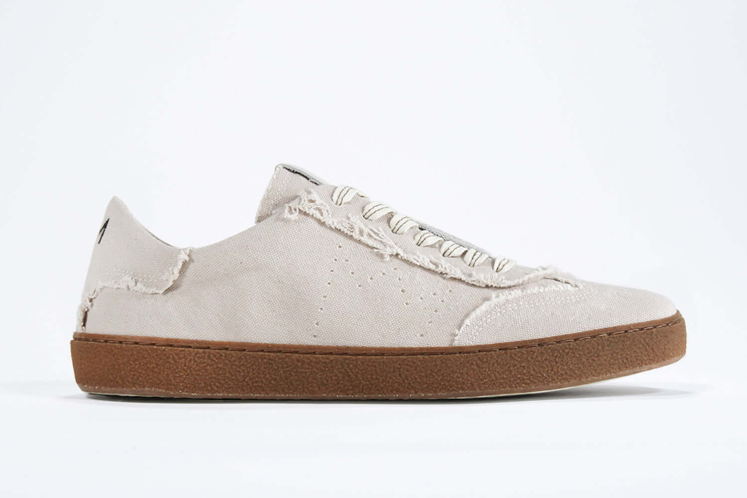 Side view of low top retro sneaker in distressed stone canvas, with honey coloured recycled rubber sole.