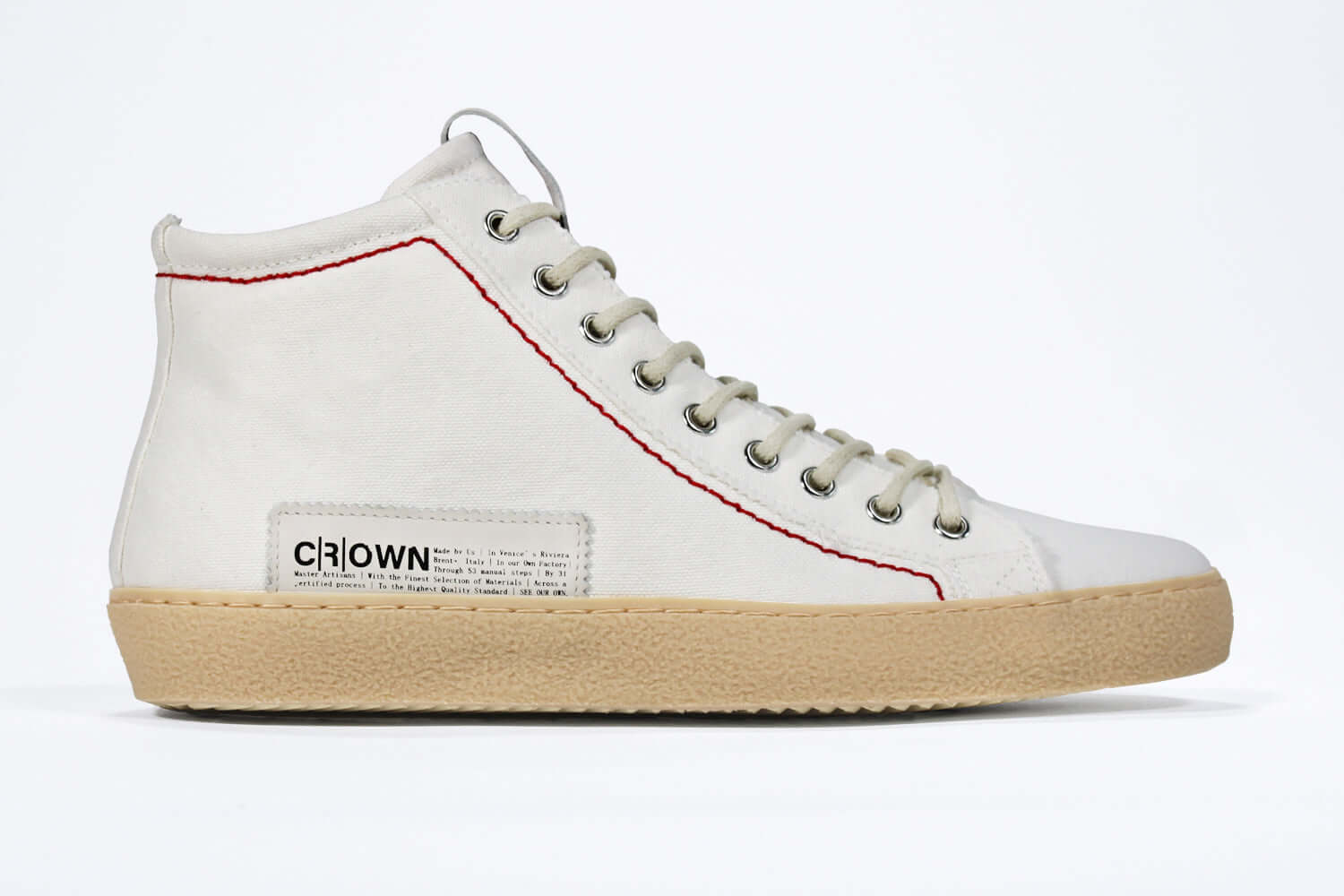 Side profile of high top canvas sneaker. Canvas white upper with signature red stitching and a pale natural rubber sole.