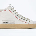 Side profile of high top canvas sneaker. Canvas white upper with signature red stitching and a pale natural rubber sole.