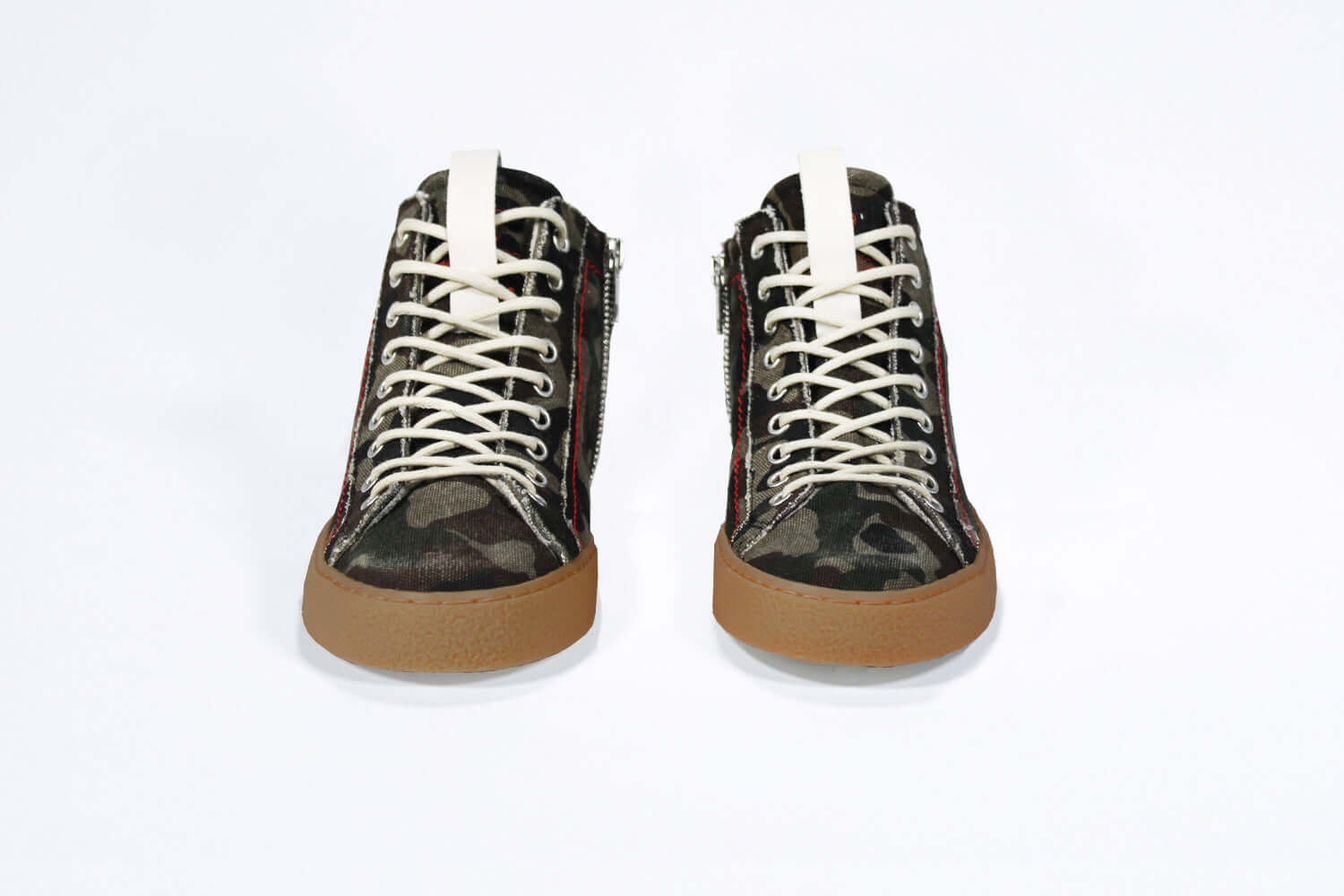 Front view of high top canvas sneaker. Camouflage canvas upper with signature red stitching and a dark natural rubber sole.