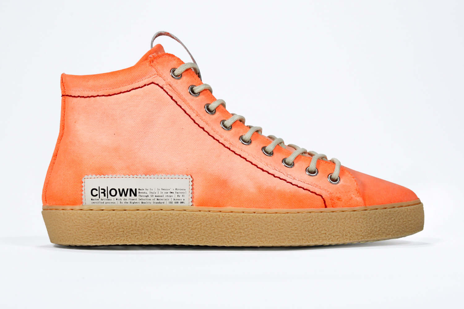 Side profile of high top canvas sneaker. Canvas upper hand painted in gradated fluo orange paint. Pale natural rubber sole.