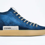 Side profile of high top canvas sneaker. Canvas upper hand painted in gradated blue paint. Pale natural rubber sole.