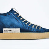 Side profile of high top canvas sneaker. Canvas upper hand painted in gradated blue paint. Pale natural rubber sole.