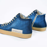 Back view of high top canvas sneaker. Canvas upper hand painted in gradated blue paint. Pale natural rubber sole.