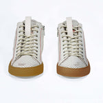 Front view of high top perforated aged white leather sneaker with signature red stitching and a dark natural rubber sole.