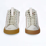 Front view of high top perforated aged white leather sneaker with signature red stitching and a dark natural rubber sole.