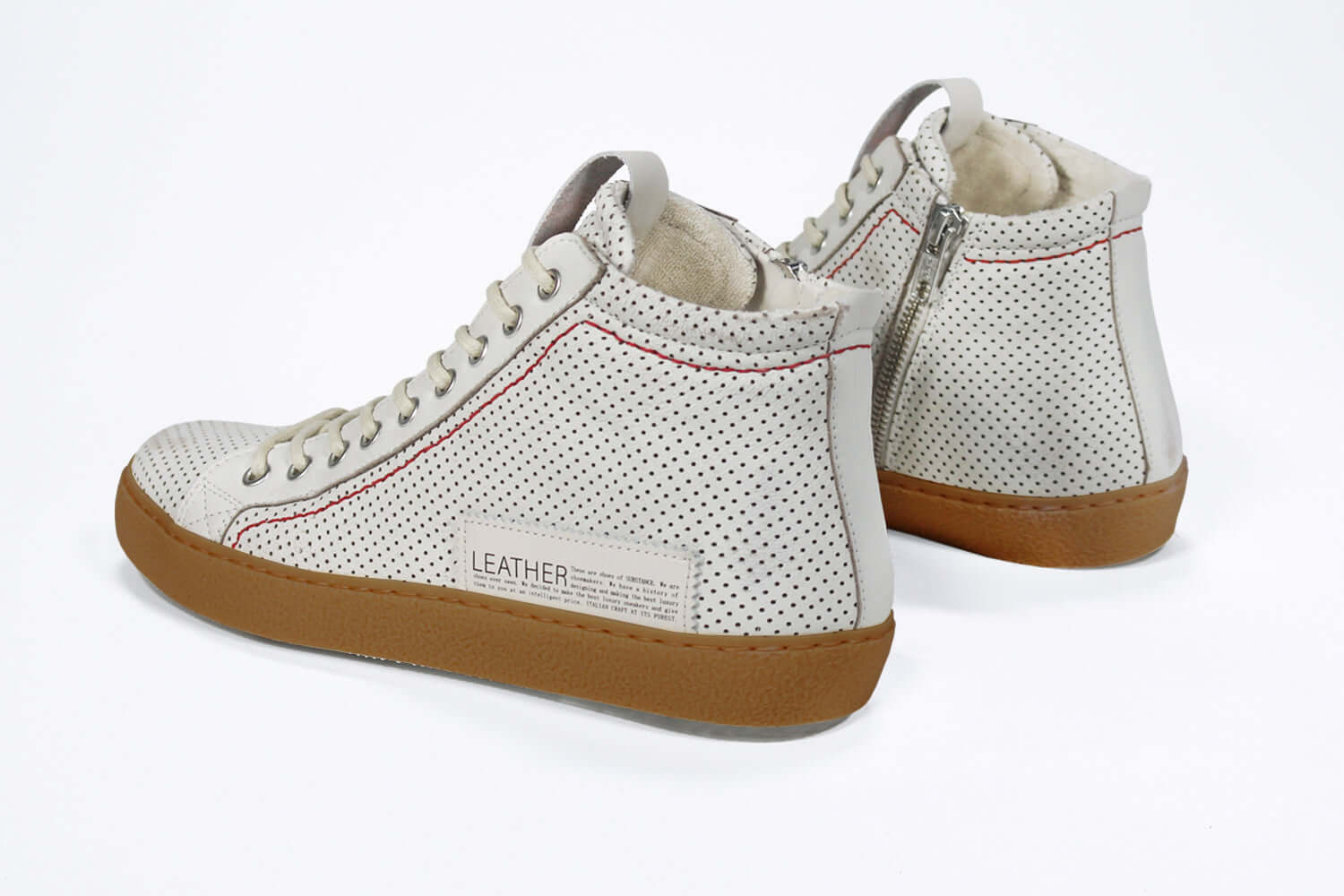 Back view of high top perforated aged white leather sneaker with signature red stitching and a dark natural rubber sole.