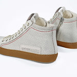 Back view of high top perforated aged white leather sneaker with signature red stitching and a dark natural rubber sole.