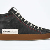 Side profile of high top perforated aged black leather sneaker with signature red stitching and a dark natural rubber sole.