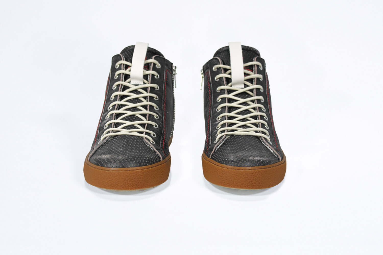 Front view of high top perforated aged black leather sneaker with signature red stitching and a dark natural rubber sole.