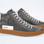 Three quarter front view of high top perforated aged black leather sneaker with signature red stitching and a dark natural rubber sole.