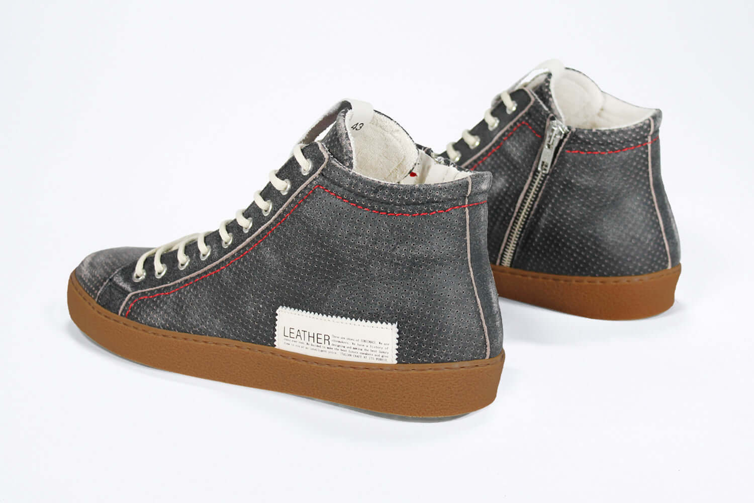 Back view of high top perforated aged black leather sneaker with signature red stitching and a dark natural rubber sole.