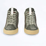 Front view of high top perforated aged khaki leather sneaker with signature red stitching and a pale natural rubber sole.