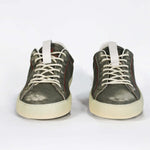 Front view of low top aged khaki sneaker with white accents. Perforated khaki leather upper with red stitching and pale rubber sole.