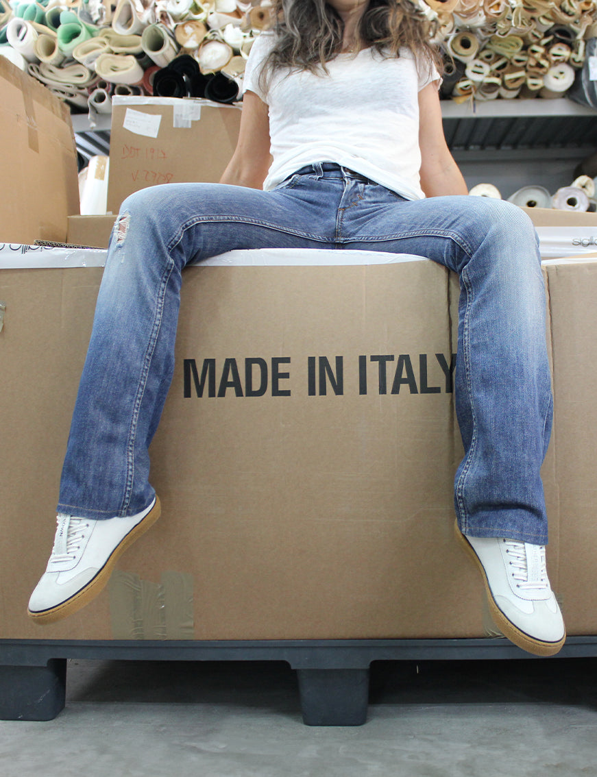 Model wearing Model T sneakers sat of Made in Italy stamped box.