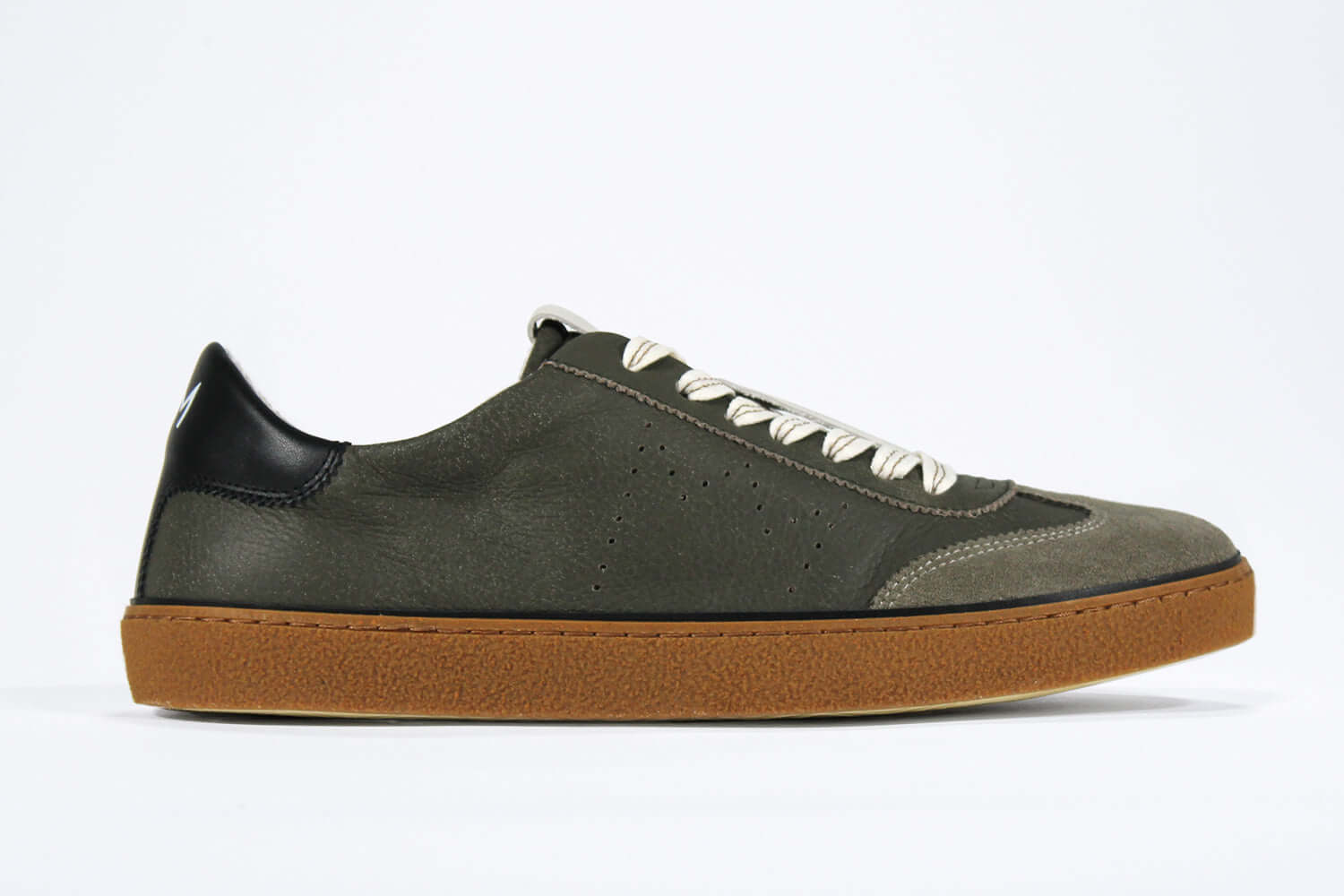 Side view of low top retro sneaker in distressed khaki leather with black detailing. Set on a honey coloured recycled rubber sole.
