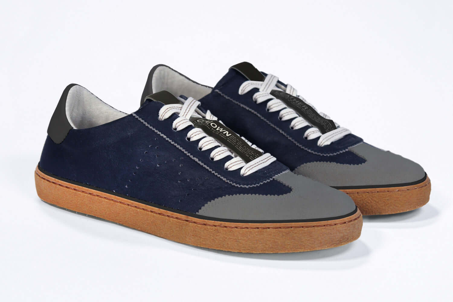 Three quarter front view of low top retro sneaker in distressed navy leather with black and grey detailing. Set on a honey coloured recycled rubber sole.
