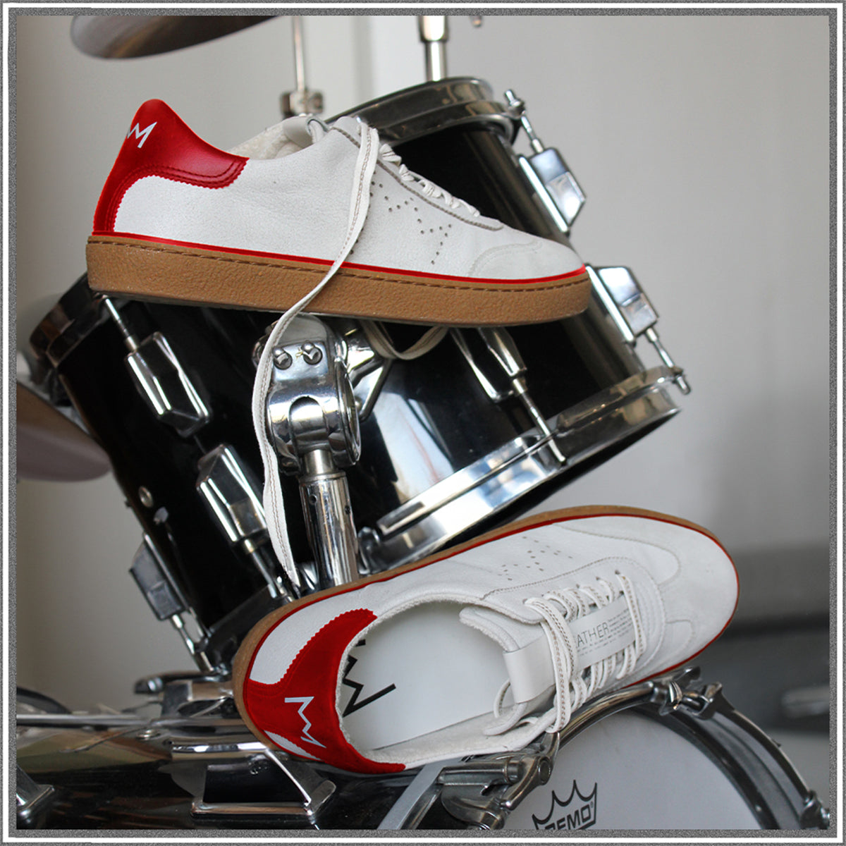 Model T retro low top sneaker style positioned on drum kit.