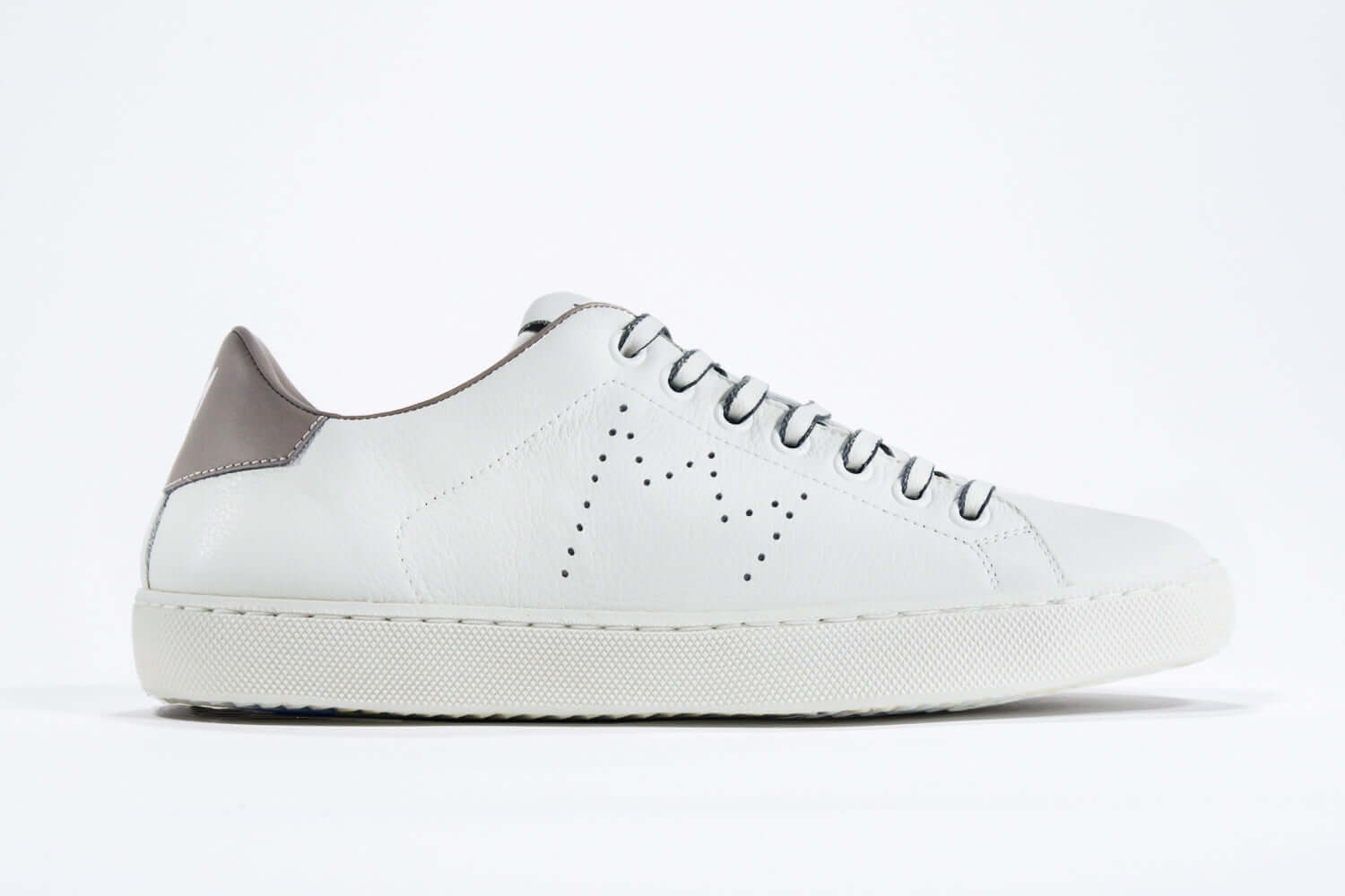 Side profile of low top white sneaker with beige detailing and perforated crown logo on upper. Full leather upper and white rubber sole.