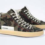 Three quarter front view of high top canvas sneaker. Camouflage print canvas upper with signature red stitching and pale natural rubber sole.