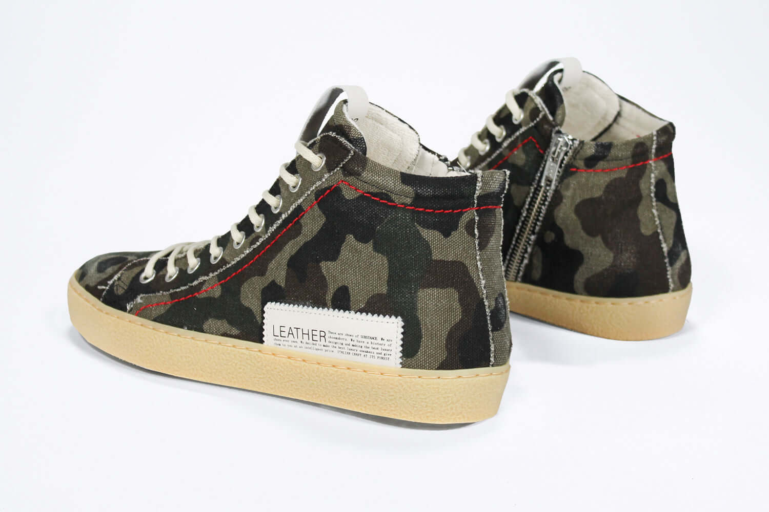 Back view of high top canvas sneaker. Camouflage print canvas upper with signature red stitching and pale natural rubber sole.