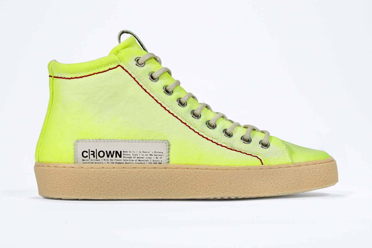 Side profile of high top canvas sneaker. Canvas upper hand painted in gradated fluo yellow paint. Pale natural rubber sole.