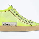 Side profile of high top canvas sneaker. Canvas upper hand painted in gradated fluo yellow paint. Pale natural rubber sole.
