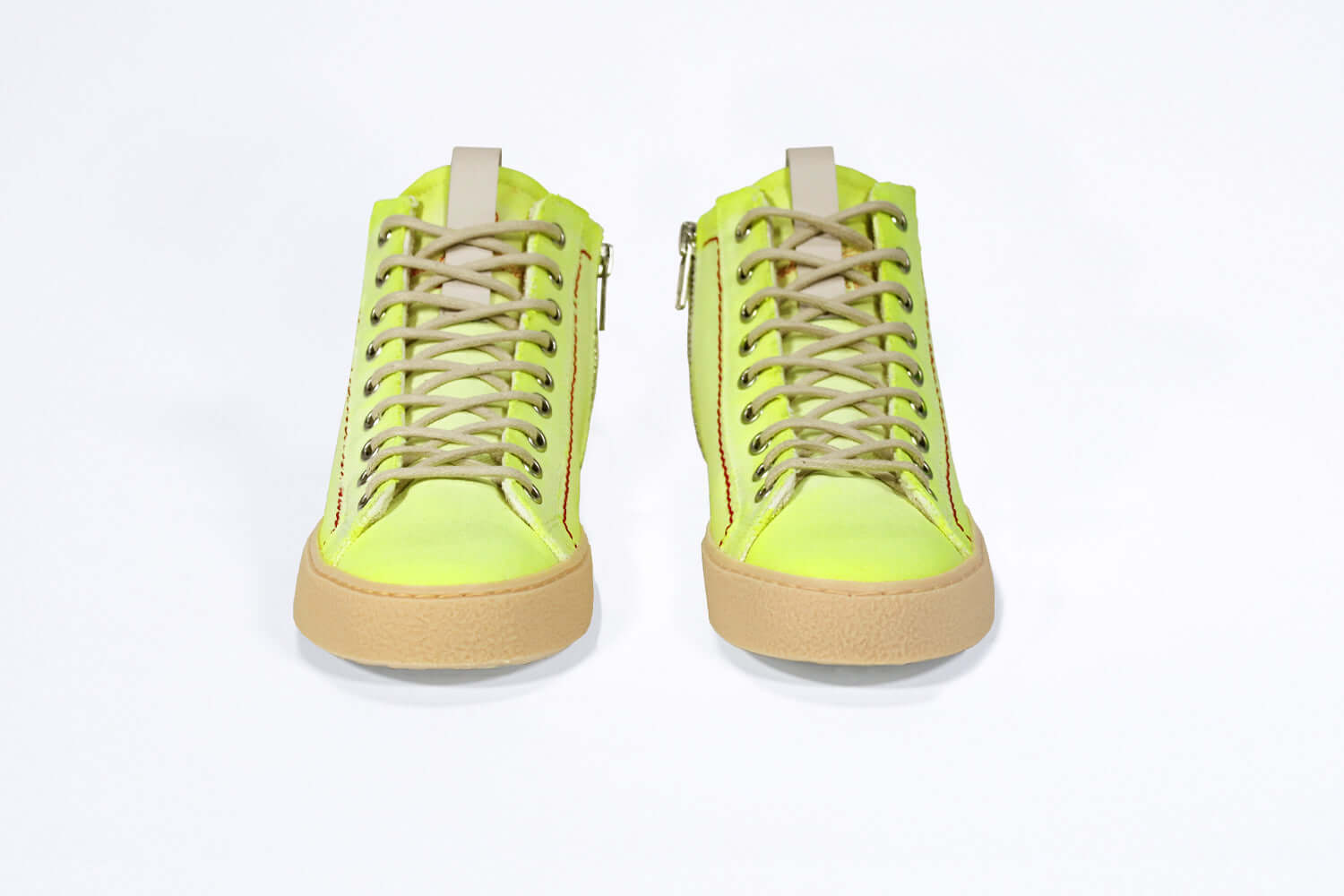 Front view of high top canvas sneaker. Canvas upper hand painted in gradated fluo yellow paint. Pale natural rubber sole.