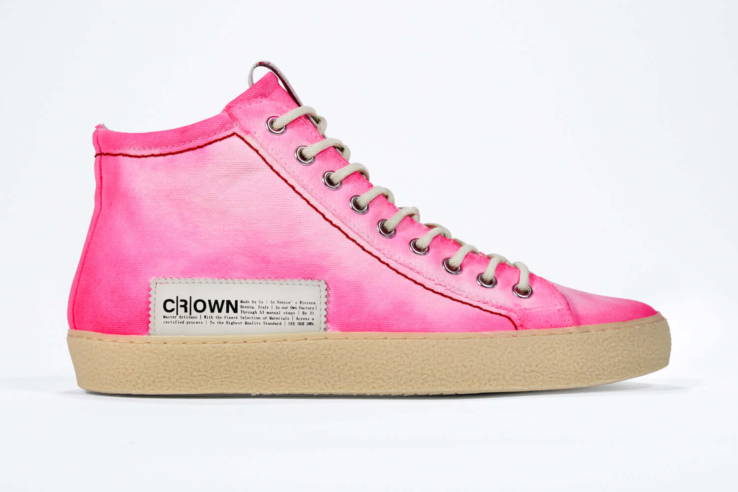 Side profile of high top canvas sneaker. Canvas upper hand painted in gradated fluo pink paint. Pale natural rubber sole.