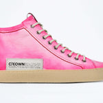 Side profile of high top canvas sneaker. Canvas upper hand painted in gradated fluo pink paint. Pale natural rubber sole.