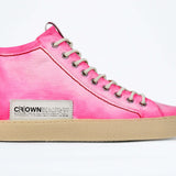 Side profile of high top canvas sneaker. Canvas upper hand painted in gradated fluo pink paint. Pale natural rubber sole.