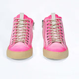 Front view of high top canvas sneaker. Canvas upper hand painted in gradated fluo pink paint. Pale natural rubber sole.