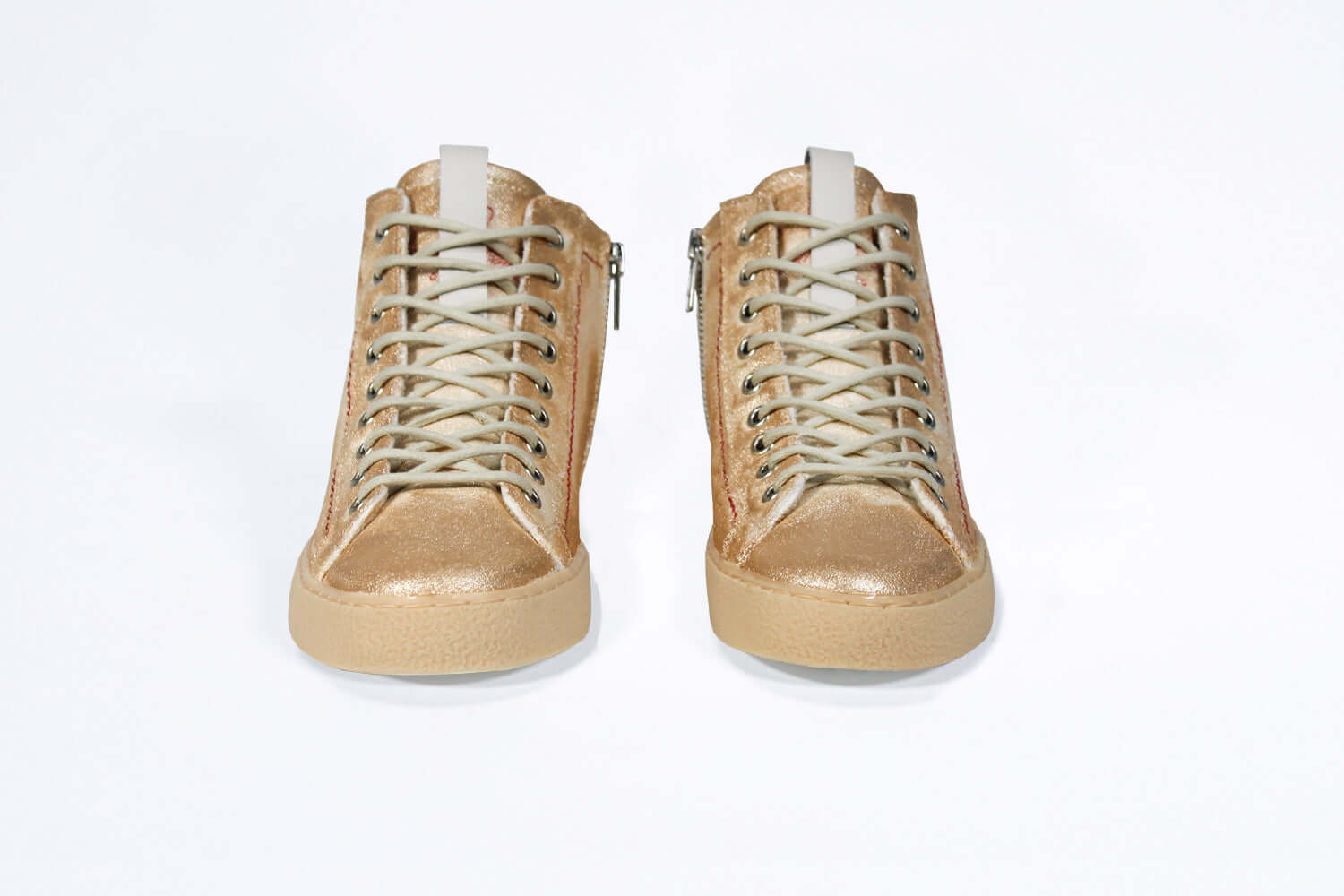 Front view of high top canvas sneaker. Canvas upper hand painted in gradated gold paint. Natural rubber sole.