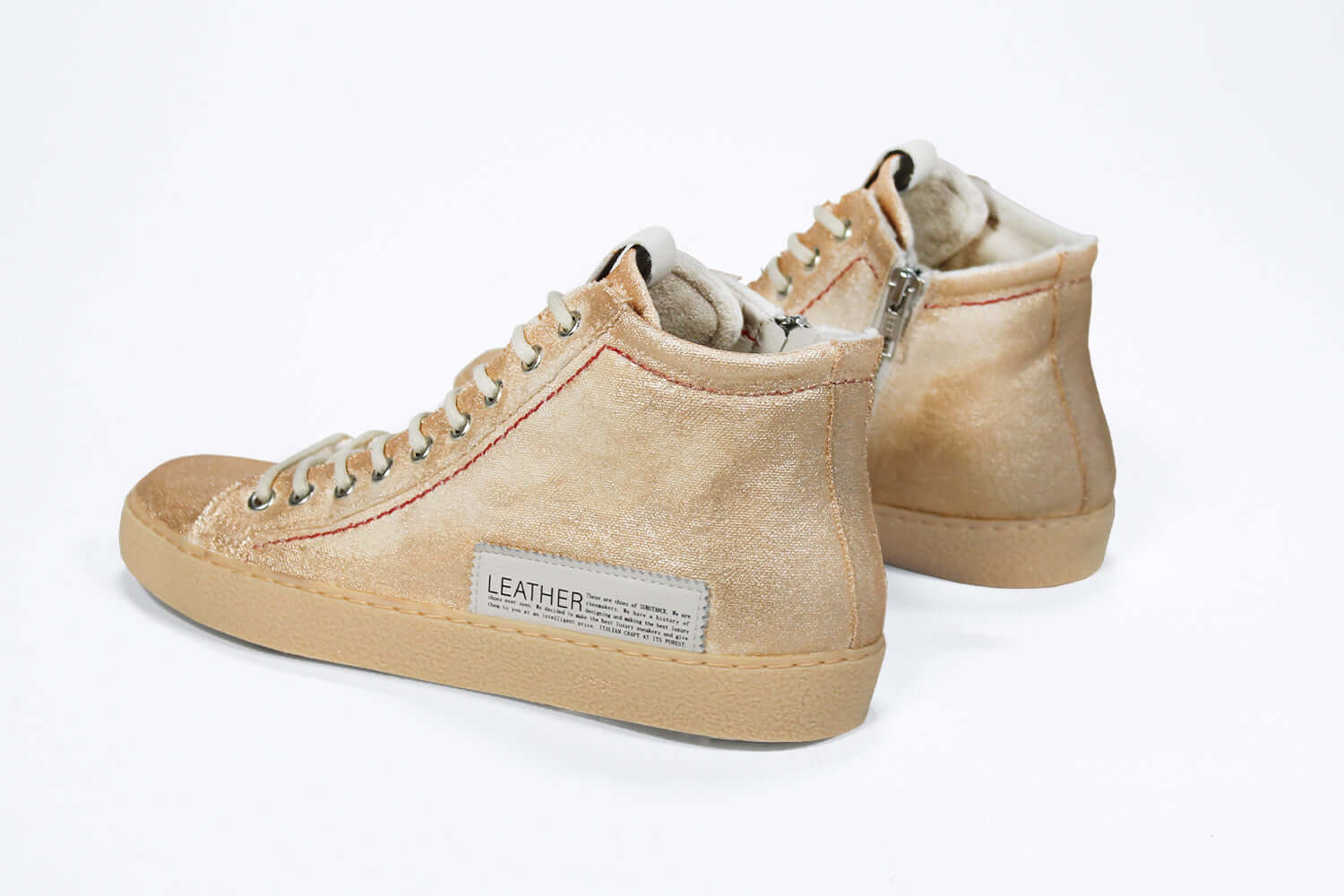 Back view of high top canvas sneaker. Canvas upper hand painted in gradated gold paint. Natural rubber sole.