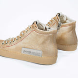 Back view of high top canvas sneaker. Canvas upper hand painted in gradated gold paint. Natural rubber sole.