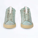 Front view of high top sneaker. Perforated sky blue leather sneakers with signature red stitching and pale natural rubber sole.