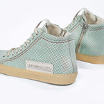 Back view of high top sneaker. Perforated sky blue leather sneakers with signature red stitching and pale natural rubber sole.