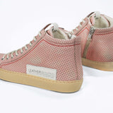 Back view of high top sneaker. Perforated pink leather sneakers with signature red stitching and pale natural rubber sole.