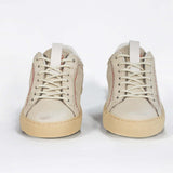 Front view of low top sneaker. Perforated milk leather sneakers with signature red stitching and pale natural rubber sole.