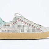 Side profile of low top perforated aged white leather sneaker with pale blue accents, red stitching detail and pale rubber sole.