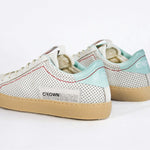 Back view of low top perforated aged white leather sneaker with pale blue accents, red stitching detail and pale rubber sole.