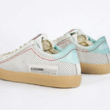 Back view of low top perforated aged white leather sneaker with pale blue accents, red stitching detail and pale rubber sole.