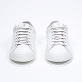 Front view of low top white sneaker with beige detailing and perforated crown logo on upper. Full leather upper and white rubber sole.