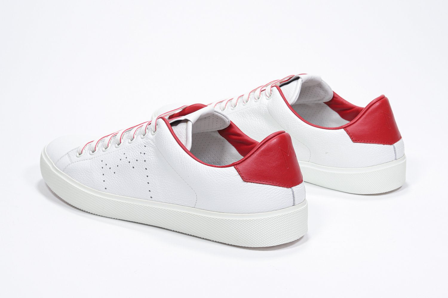 Three quarter back view of low top white sneaker with red detailing and perforated crown logo on upper. Full leather upper and white rubber sole.