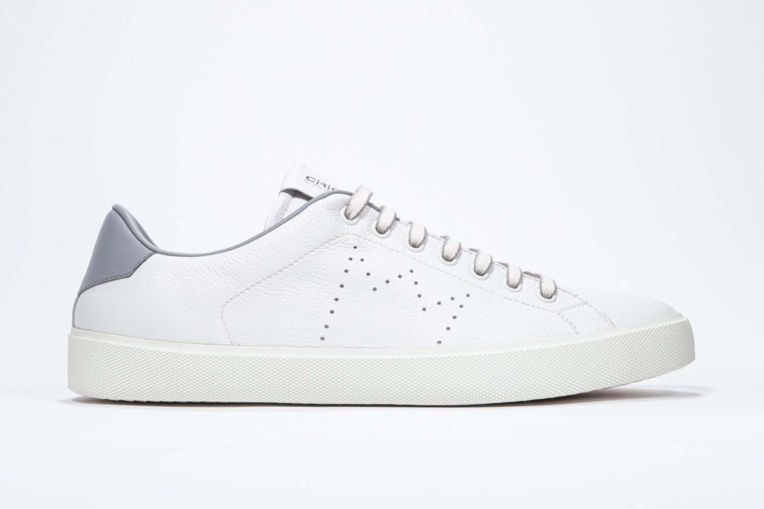 Side profile of low top white sneaker with light grey detailing and perforated crown logo on upper. Full leather upper and white rubber sole.
