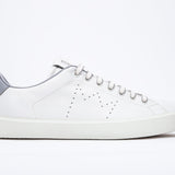 Side profile of low top white sneaker with light grey detailing and perforated crown logo on upper. Full leather upper and white rubber sole.